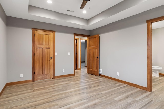 unfurnished bedroom featuring light wood-type flooring, visible vents, and baseboards