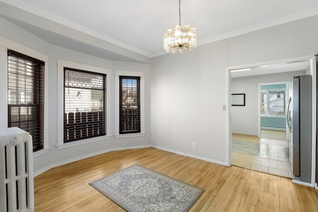 interior space with a notable chandelier, baseboard heating, radiator heating unit, and light wood-style floors