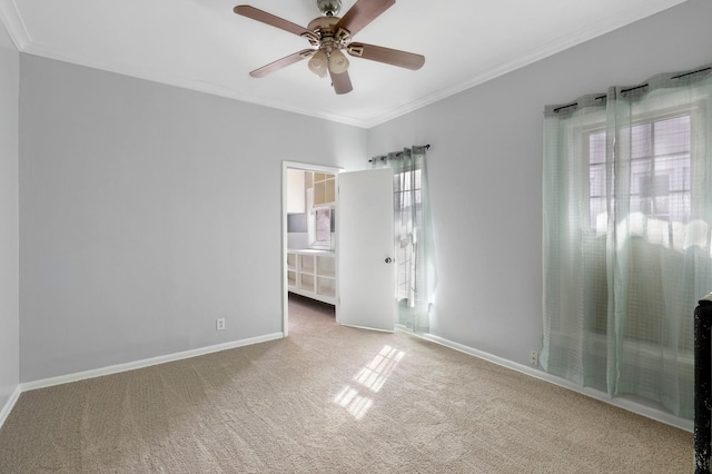 spare room featuring ceiling fan, baseboards, carpet floors, and ornamental molding