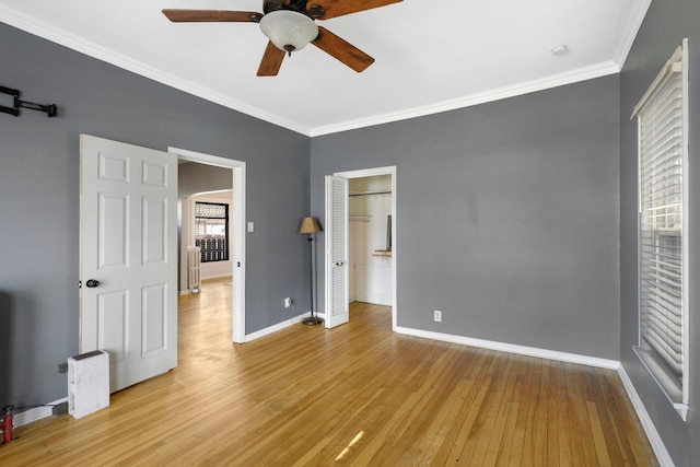 unfurnished bedroom featuring ornamental molding, hardwood / wood-style flooring, radiator, baseboards, and ceiling fan