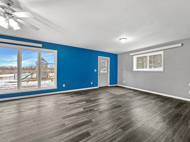 unfurnished room featuring ceiling fan, wood finished floors, and baseboards