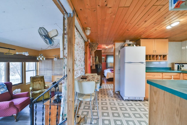 kitchen with wood ceiling and freestanding refrigerator