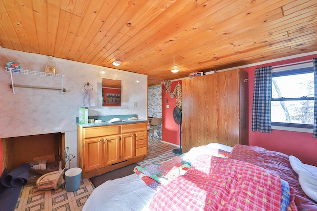 bedroom with wood ceiling and tile patterned floors