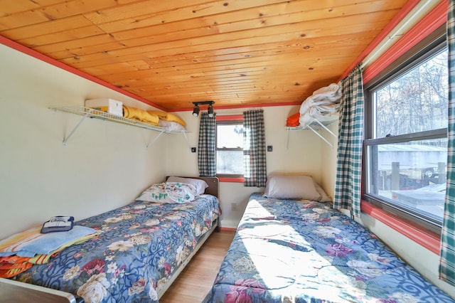 bedroom featuring wood ceiling and wood finished floors