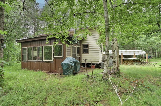 rear view of property featuring board and batten siding