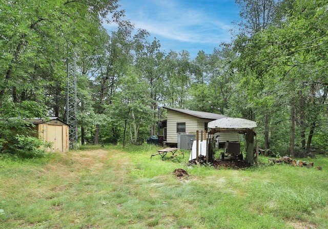 view of yard with a storage shed and an outbuilding