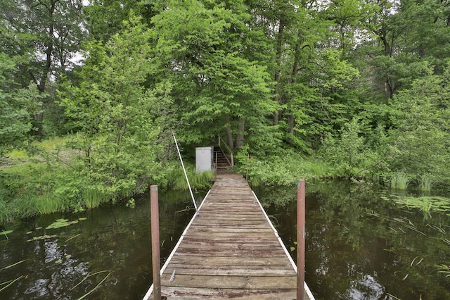 view of dock with a forest view