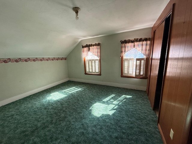 bonus room with carpet flooring, vaulted ceiling, and baseboards