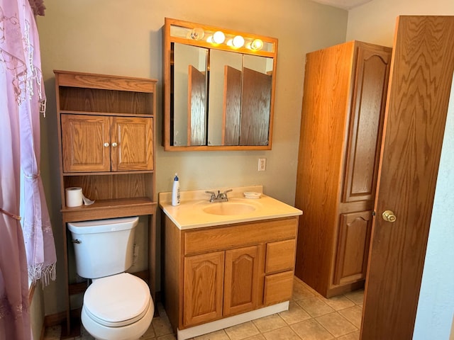 bathroom featuring vanity, tile patterned flooring, and toilet