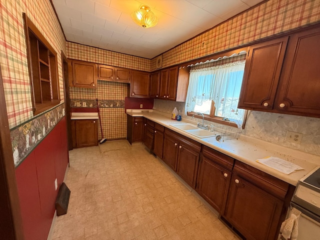 kitchen featuring wallpapered walls, light floors, and a sink