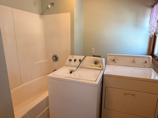 clothes washing area featuring washer and dryer