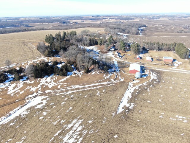 snowy aerial view featuring a rural view