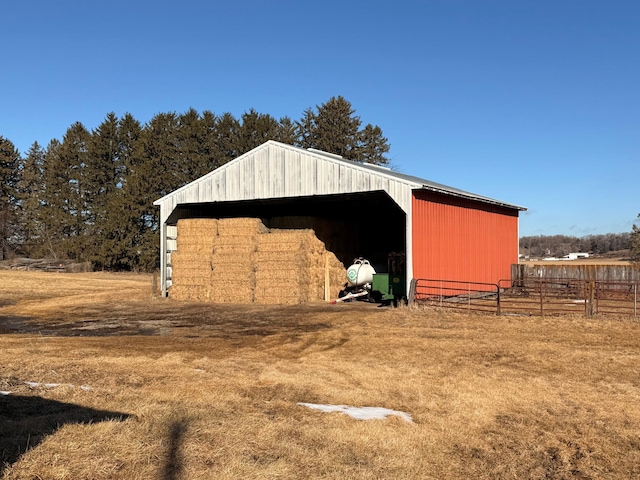 view of pole building with fence