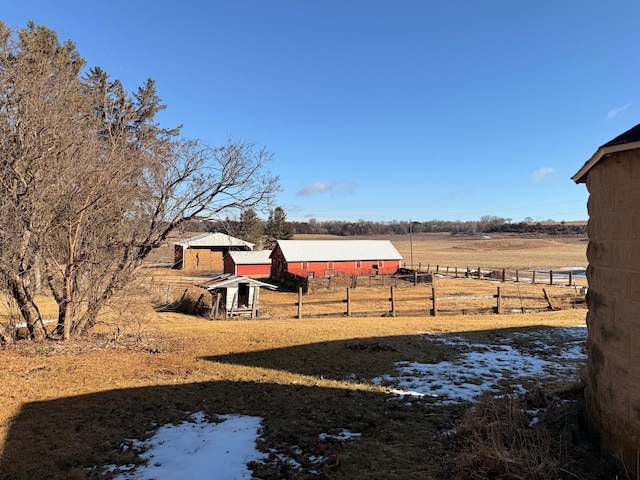 view of yard featuring a rural view and fence