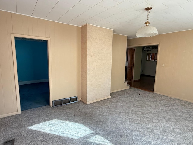 carpeted spare room featuring visible vents