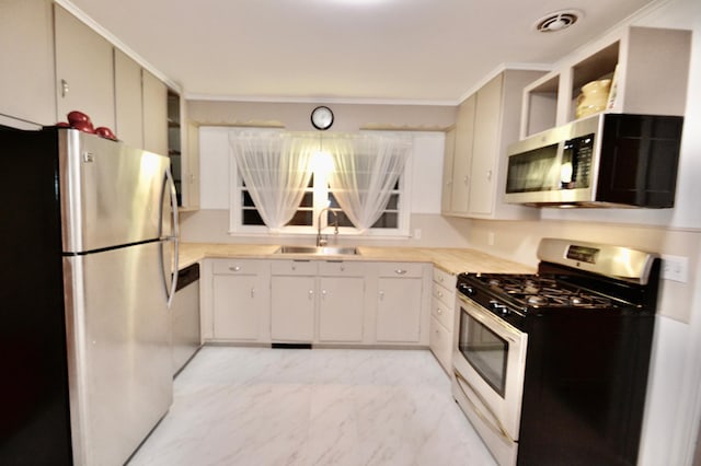 kitchen with visible vents, light countertops, marble finish floor, stainless steel appliances, and a sink