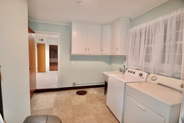 clothes washing area featuring visible vents, washing machine and dryer, light carpet, cabinet space, and a sink