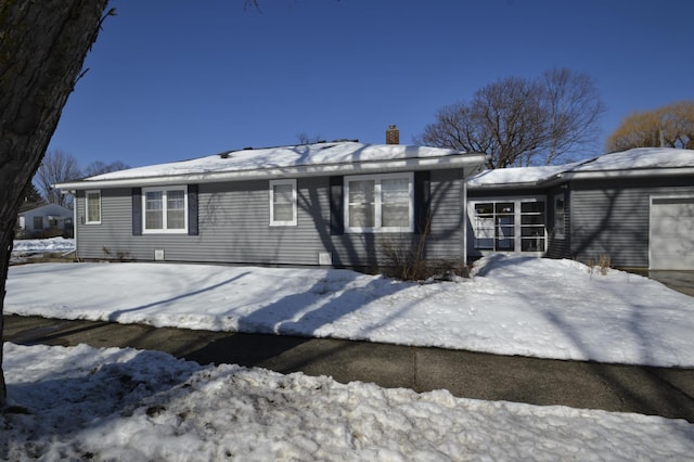 snow covered property featuring a chimney