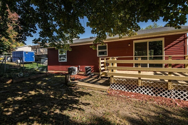 rear view of property with a wooden deck