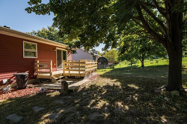 view of yard featuring fence and a wooden deck