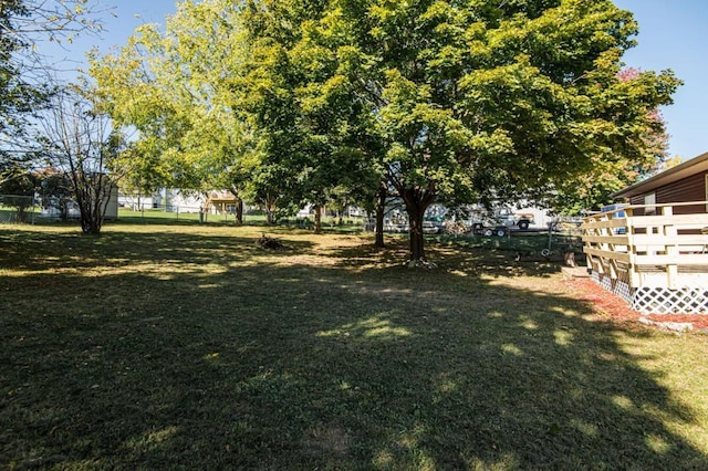 view of yard with a deck and fence