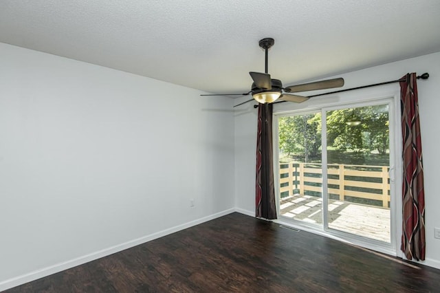 unfurnished room with baseboards, a textured ceiling, ceiling fan, and dark wood-style flooring