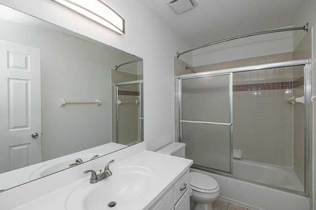 full bath with vanity, visible vents, enclosed tub / shower combo, a textured ceiling, and toilet