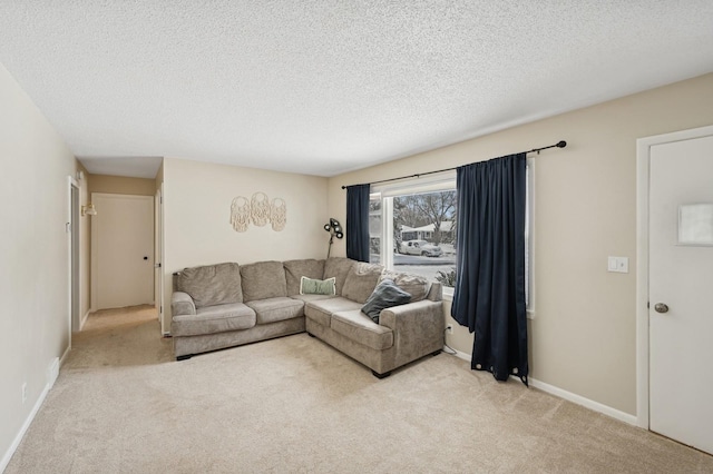 living room with light carpet, a textured ceiling, and baseboards