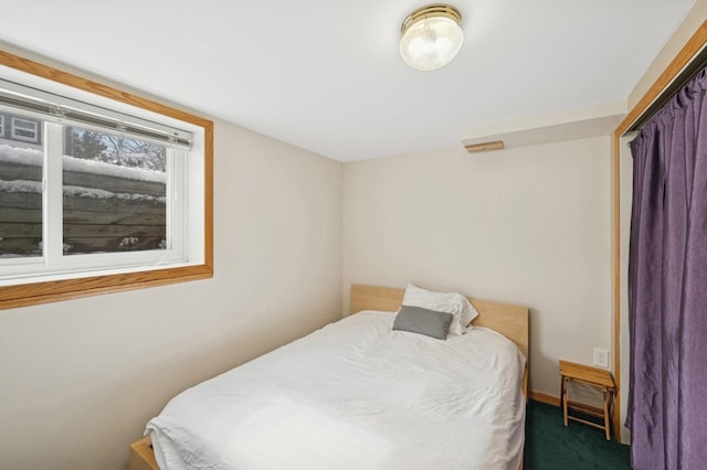 bedroom featuring carpet and baseboards