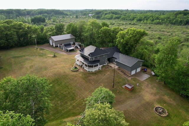 drone / aerial view with a wooded view