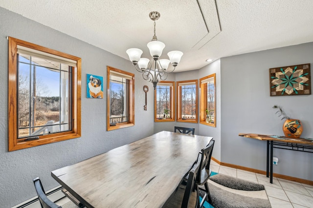 dining area featuring light tile patterned floors, a healthy amount of sunlight, baseboards, and a chandelier