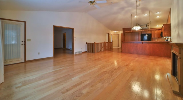 unfurnished living room with light wood finished floors, visible vents, baseboards, high vaulted ceiling, and a ceiling fan