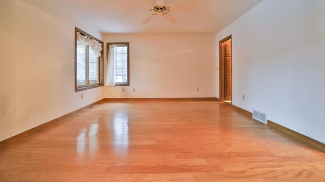 unfurnished room with visible vents, baseboards, and light wood finished floors