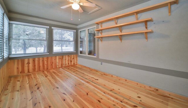 empty room featuring wood-type flooring and ceiling fan