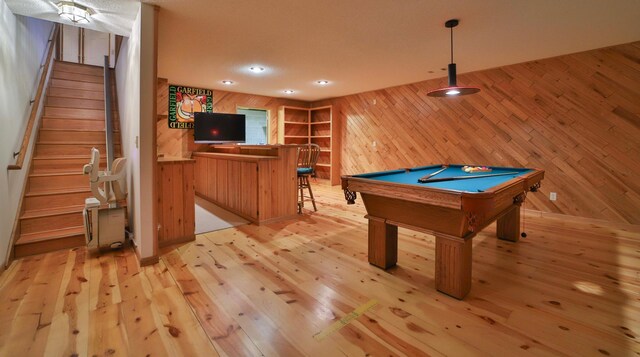 recreation room featuring pool table, wood walls, a dry bar, recessed lighting, and light wood-style floors