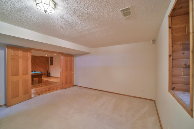 additional living space with visible vents, carpet, billiards, and a textured ceiling