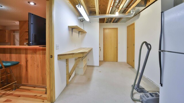 interior space featuring a bar and freestanding refrigerator