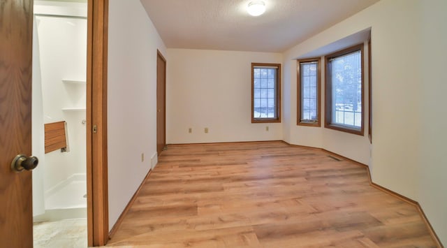 14686 Par Dr, Baxter, MN 56425 - spare room featuring a textured ceiling and light wood-style flooring