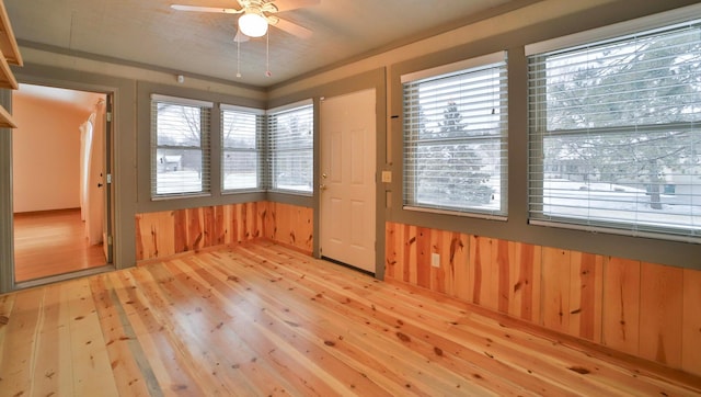 14686 Par Dr, Baxter, MN 56425 - unfurnished room with wood walls, ceiling fan, and light wood finished floors
