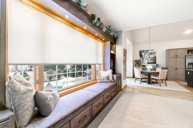 living room with light colored carpet, recessed lighting, baseboards, and light wood finished floors