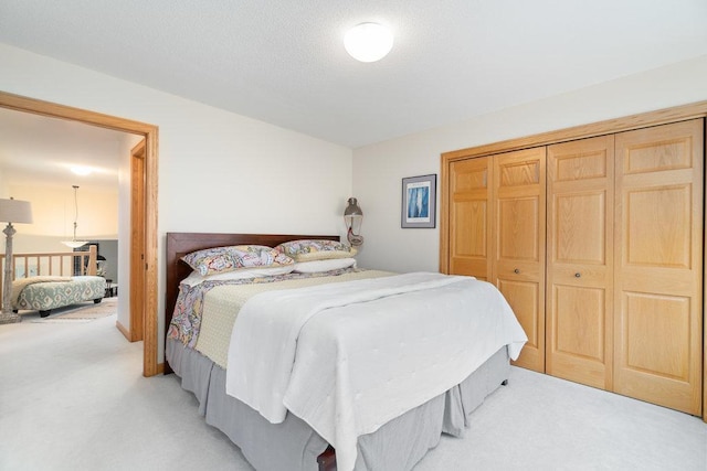bedroom featuring light carpet and a closet