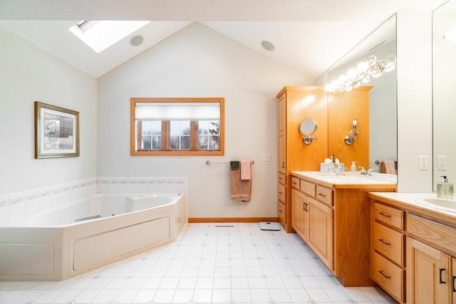 bathroom with lofted ceiling with skylight, tile patterned floors, two vanities, a bath, and a sink