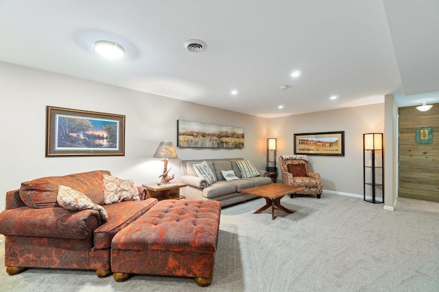 carpeted living area featuring baseboards, recessed lighting, and visible vents