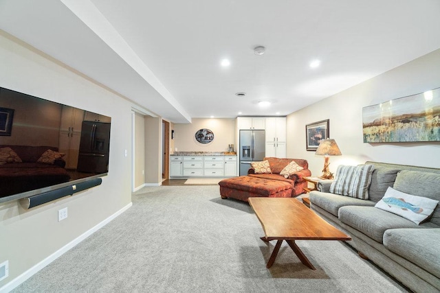 living room featuring baseboards, light carpet, and recessed lighting