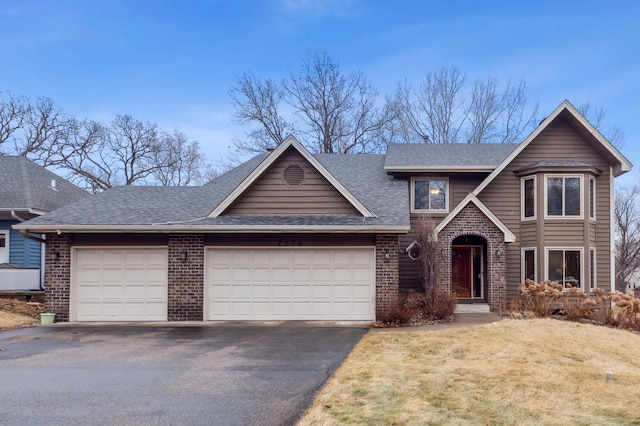 view of front of property featuring aphalt driveway, roof with shingles, an attached garage, a front lawn, and brick siding