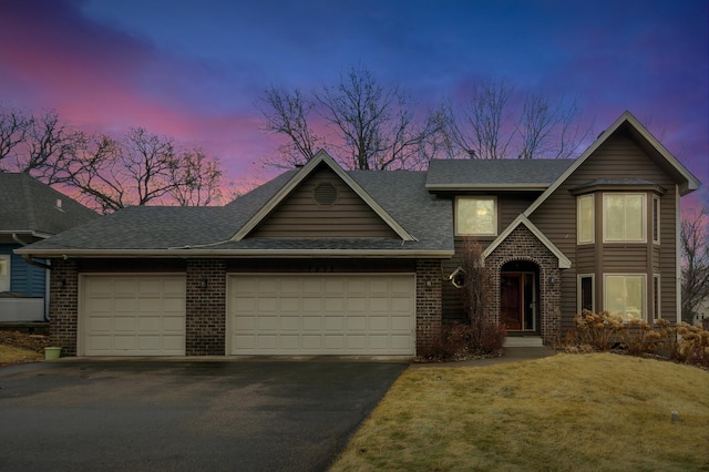 view of front of property featuring driveway, brick siding, roof with shingles, and an attached garage