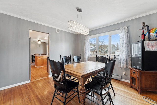 dining space featuring baseboards, a baseboard radiator, ceiling fan, crown molding, and light wood-style floors