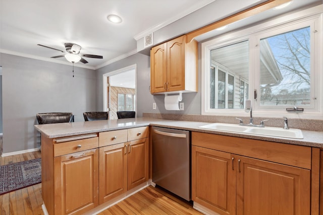 kitchen with ornamental molding, a peninsula, light countertops, stainless steel dishwasher, and a sink