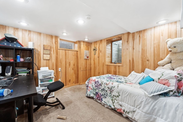 carpeted bedroom featuring wooden walls and recessed lighting