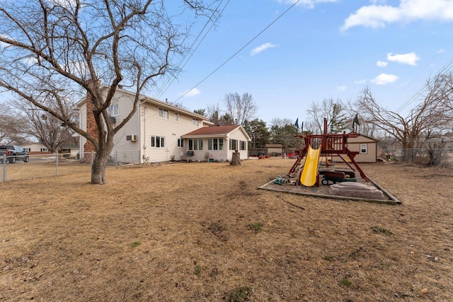 exterior space with a playground and fence